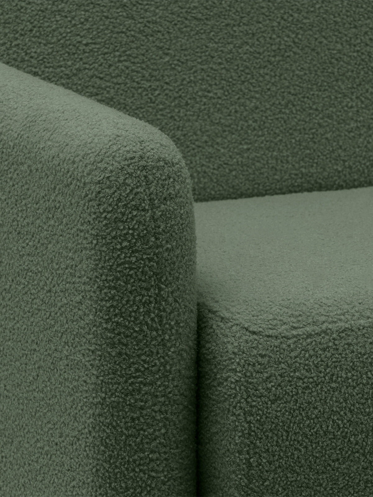 Zielona sofa rozkładana Nido boucle Quelle 37, detal narożnika z tkaniny boucle